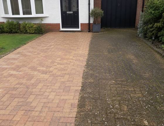 A block paving driveway half cleaned