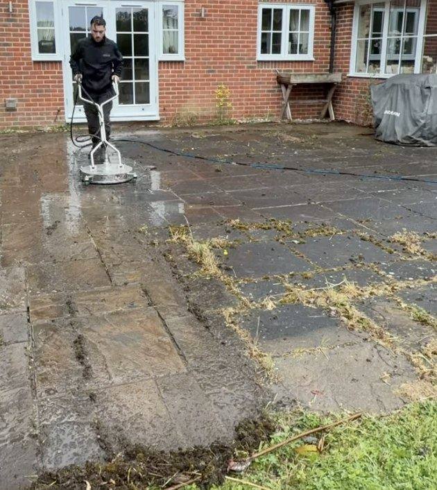 Kiln dried sand being worked back into block paving joints