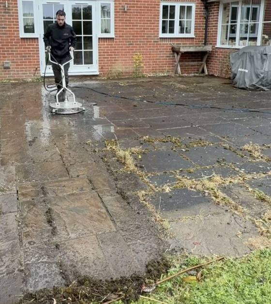 Kiln dried sand being worked into block paving joints