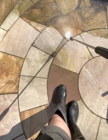 Circular patio being pressure washed