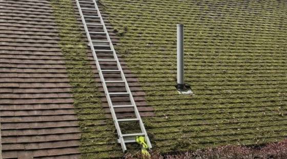 Ladder access set up for clearing a blocked gutter