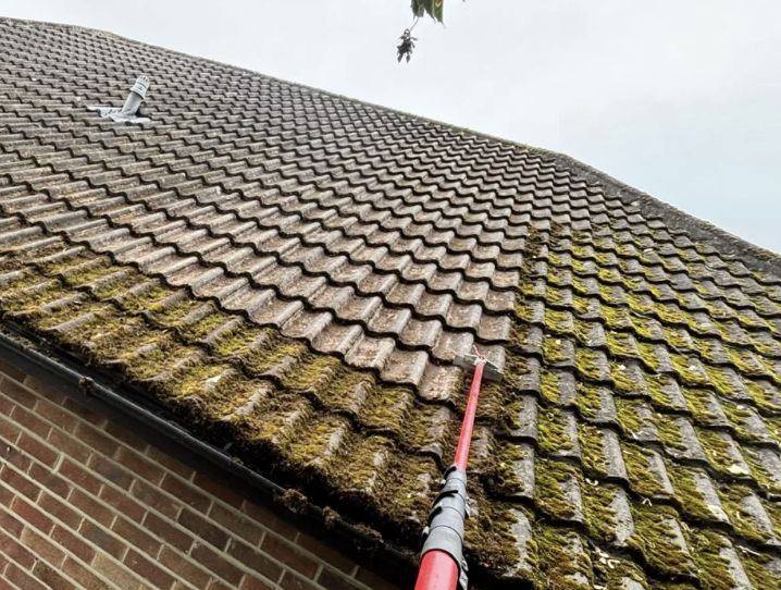 Close up of moss scraped away from roof tiles