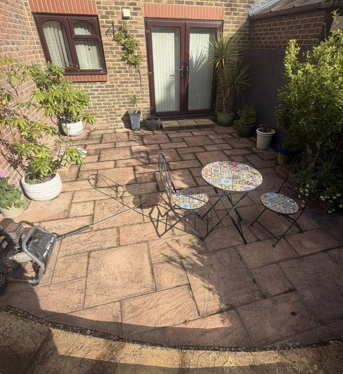 Patio darkened by algae and dirt before cleaning