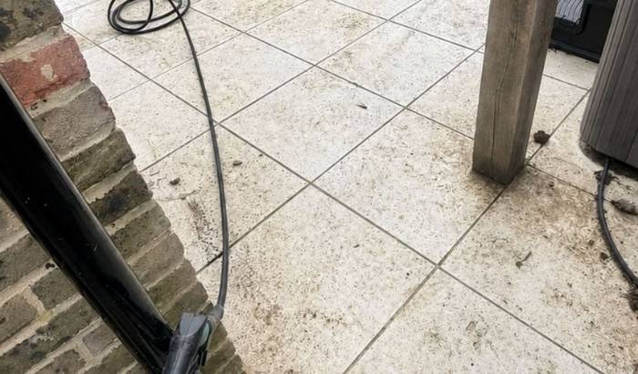 Porcelain patio dulled with dirt before cleaning