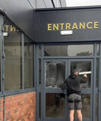 Glass entrance being cleaned
